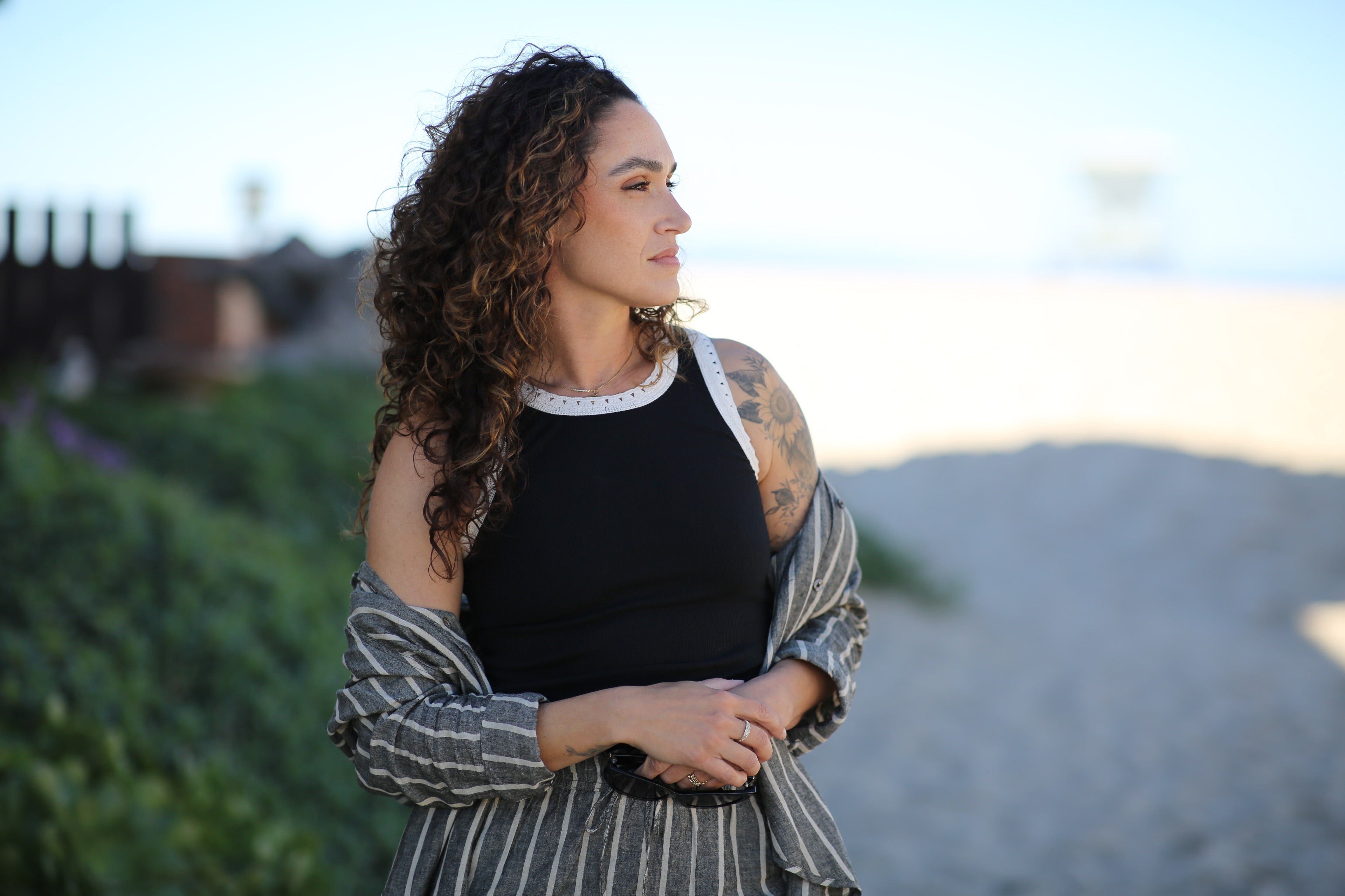 Woman standing outdoors with a blurred background